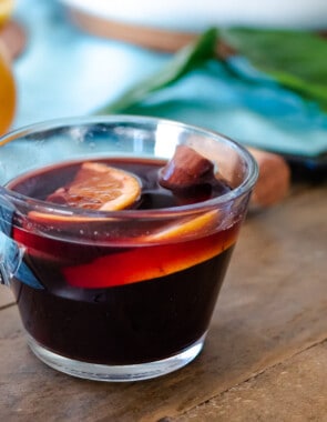 on cup of mulled wine with orange slices and a cinnamon stick.