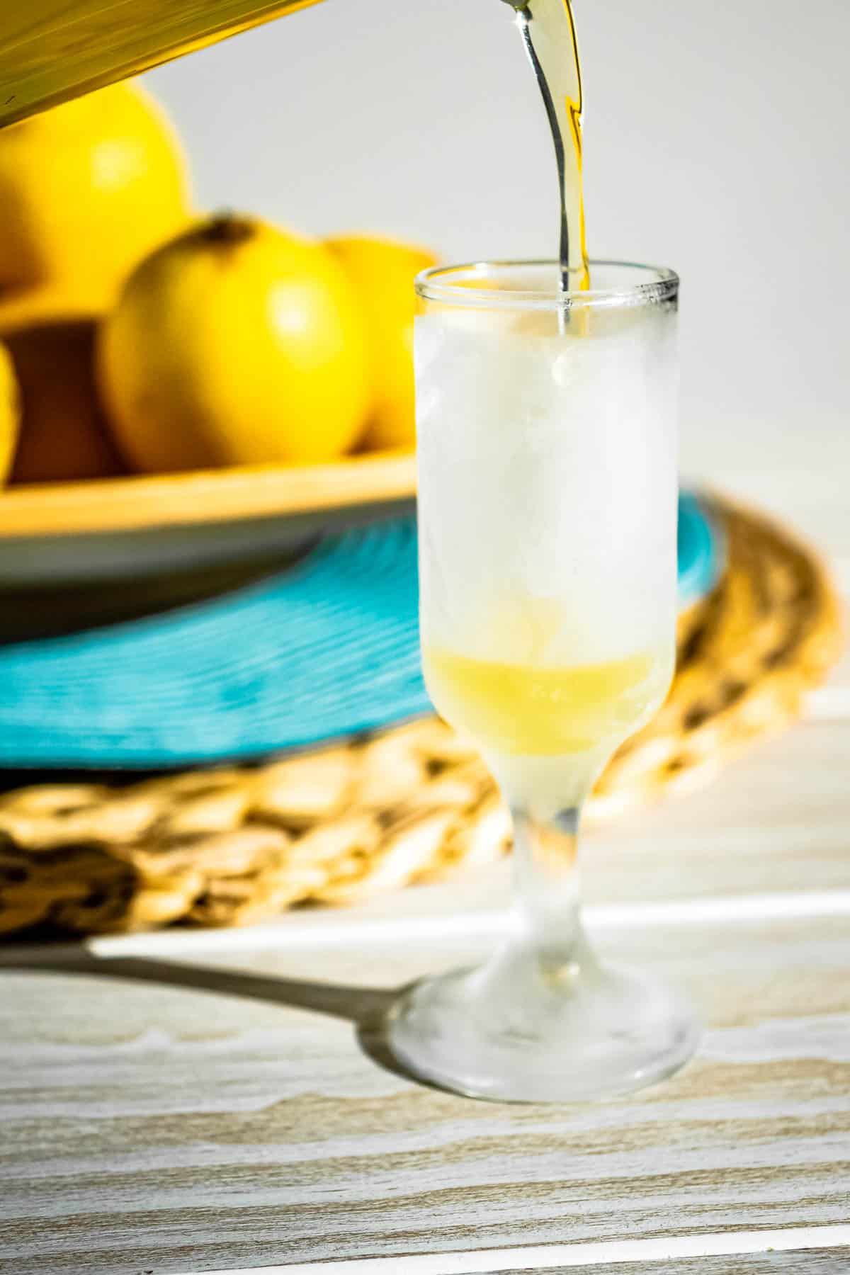 limoncello being poured into a glass.