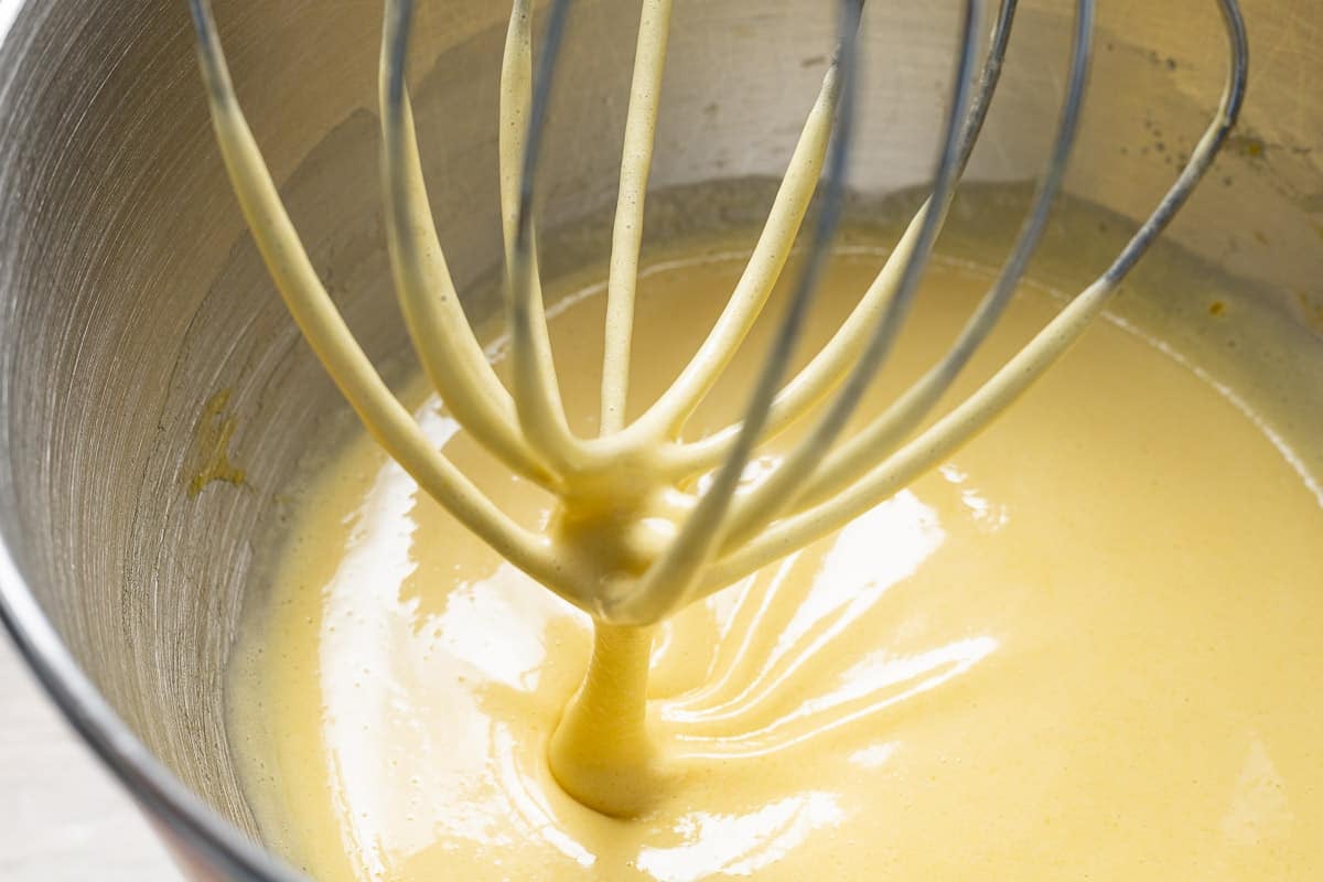 eggs, oil, extracts and sugar in the bowl of a stand mixer with a whisk attachment.