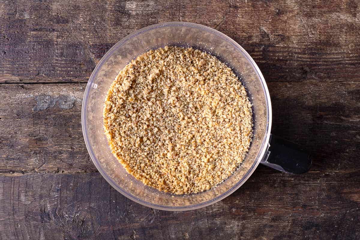 ground walnuts in the bowl of a food processor.