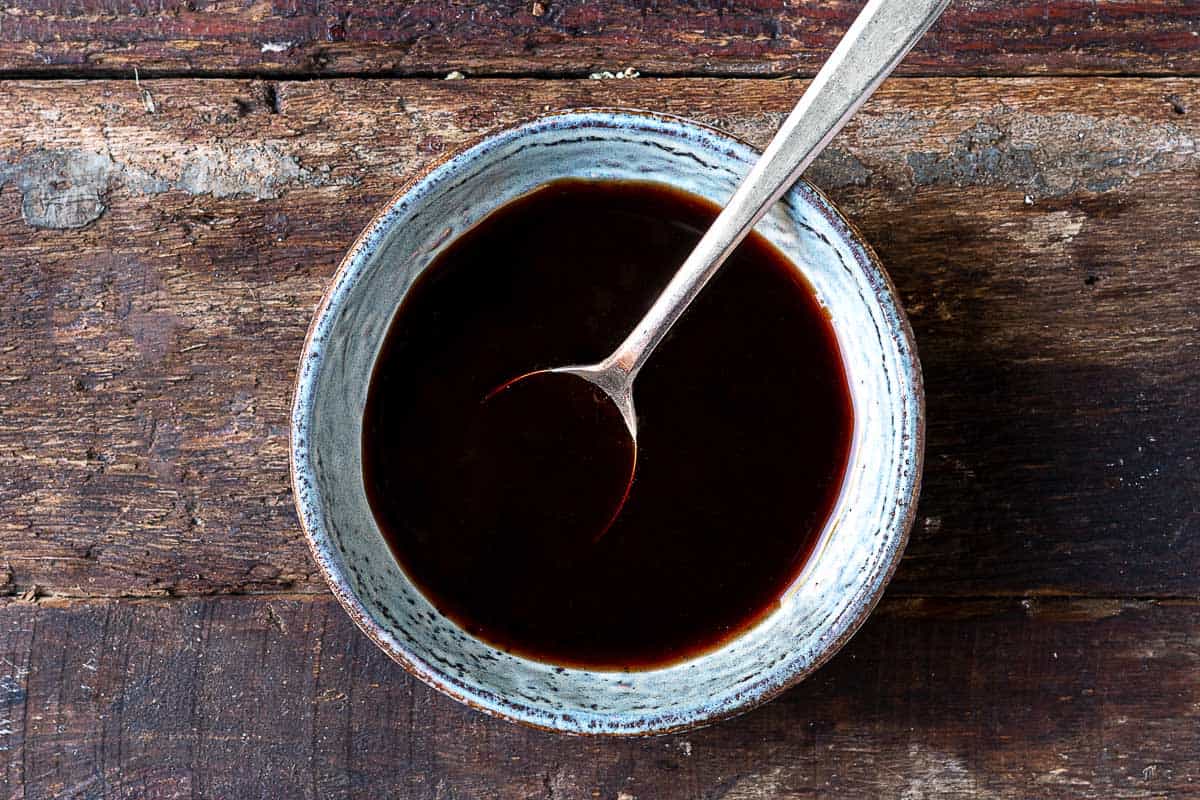 pomegranate dressing in a bowl with a spoon.