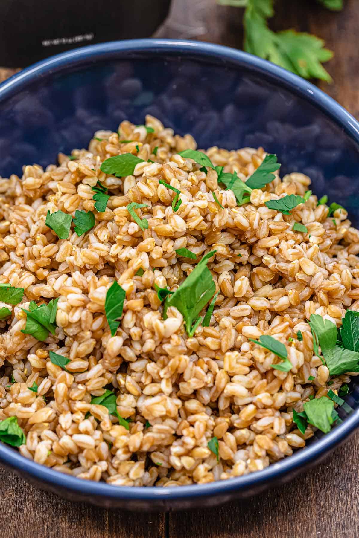 cooked farro garnished with parsley in a bowl.