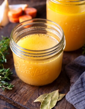 cooked chicken stock in two glass jars.