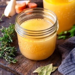 cooked chicken stock in two glass jars.