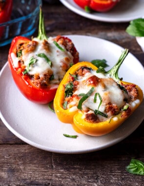two cooked stuffed pepper halves on a plate.