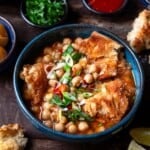 lablabi tunisian chickpea stew in a bowl, next to bowls of various toppings.