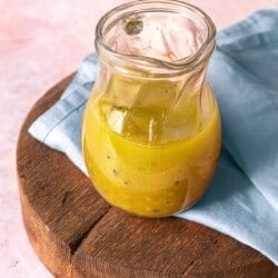 apple cider vinaigrette in a small glass pitcher.