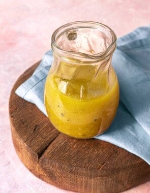 apple cider vinaigrette in a small glass pitcher.