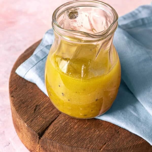 apple cider vinaigrette in a small glass pitcher.