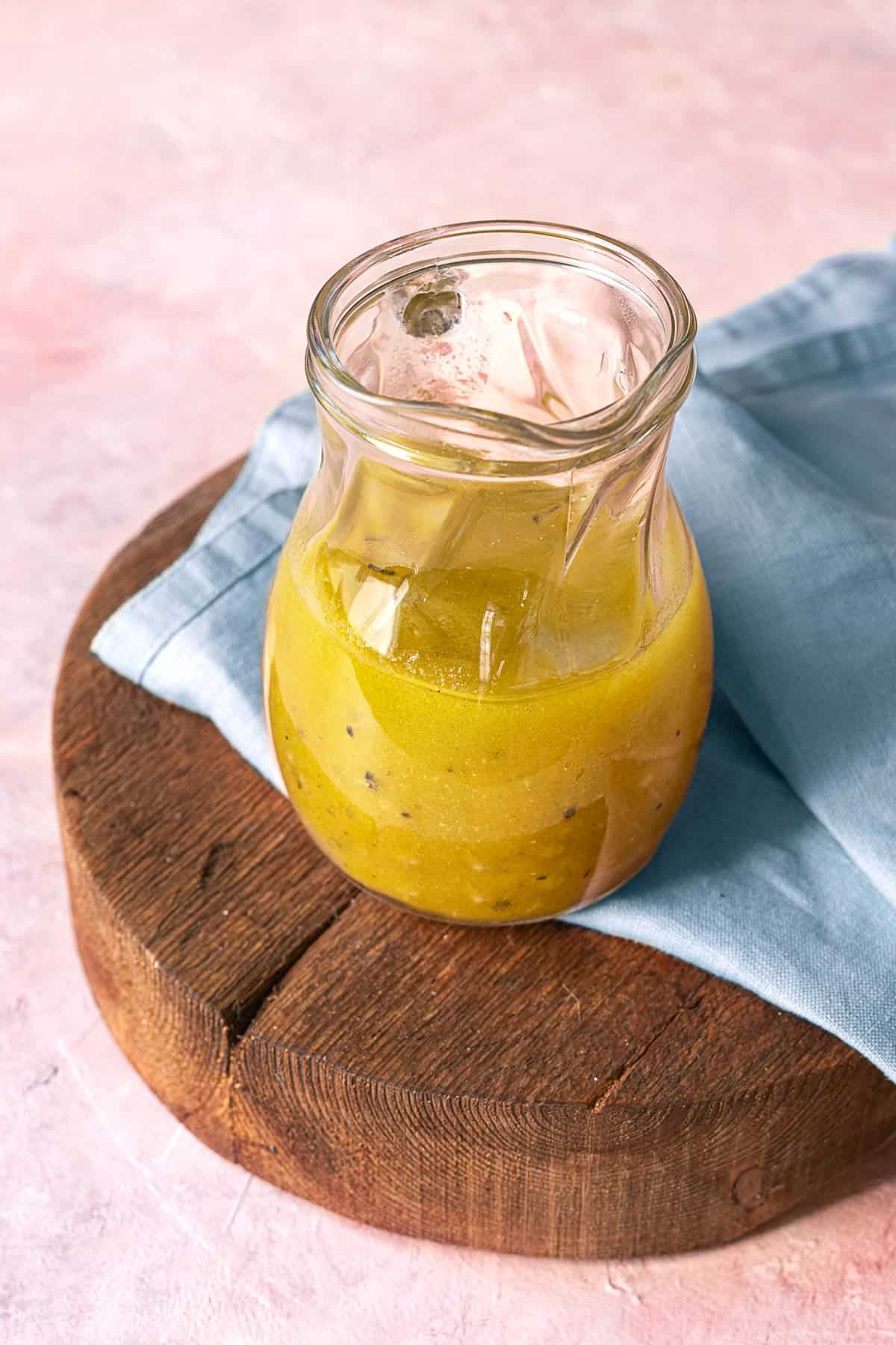 apple cider vinaigrette in a small glass pitcher.