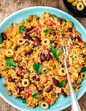 spanish rice and beans on a plate with a fork.