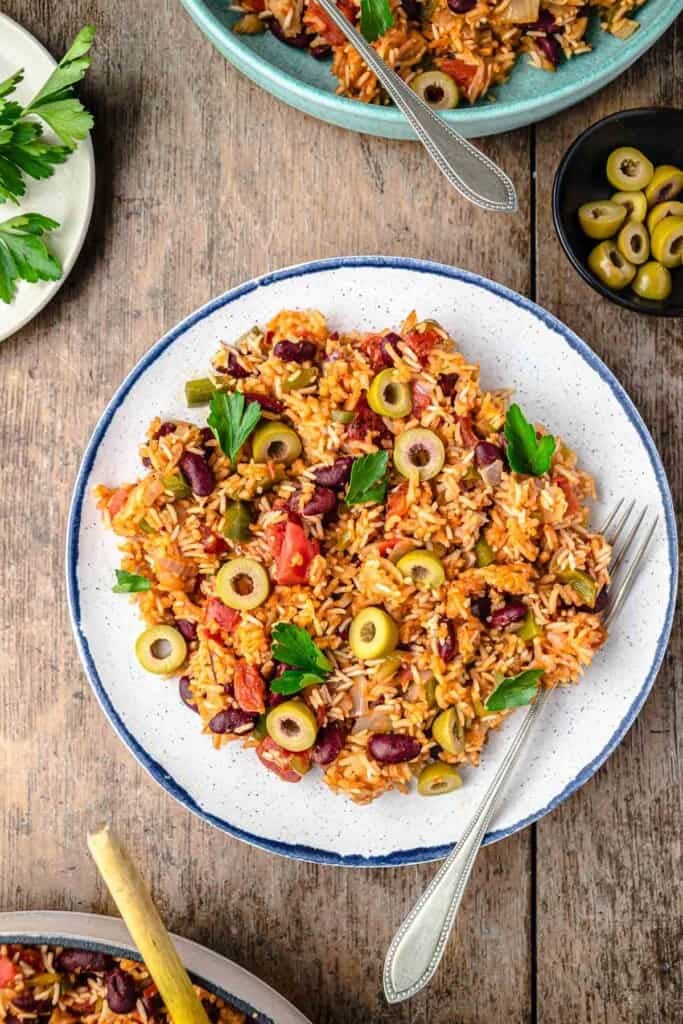 spanish rice and beans on a plate with a fork.