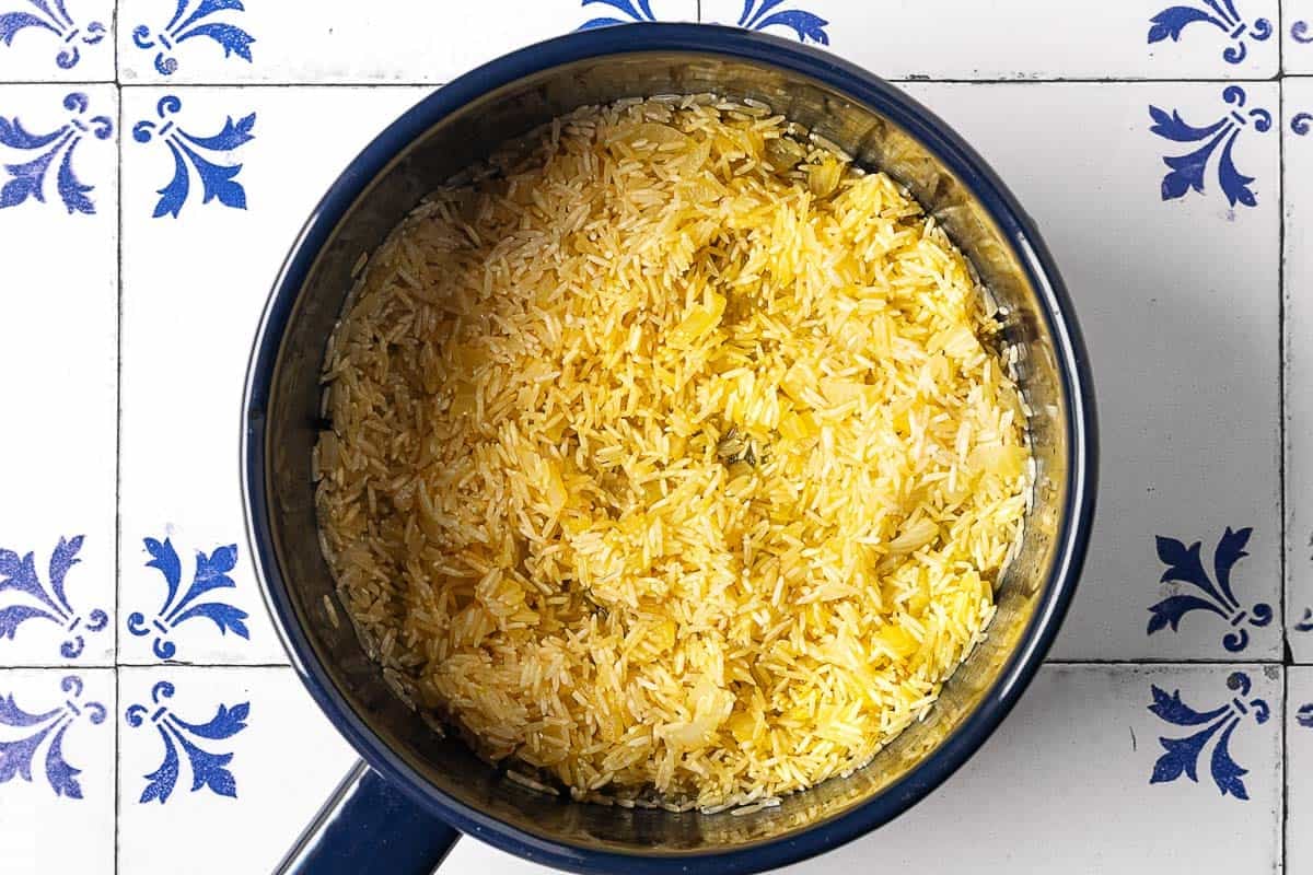 saffron rice cooking in a saucepan.