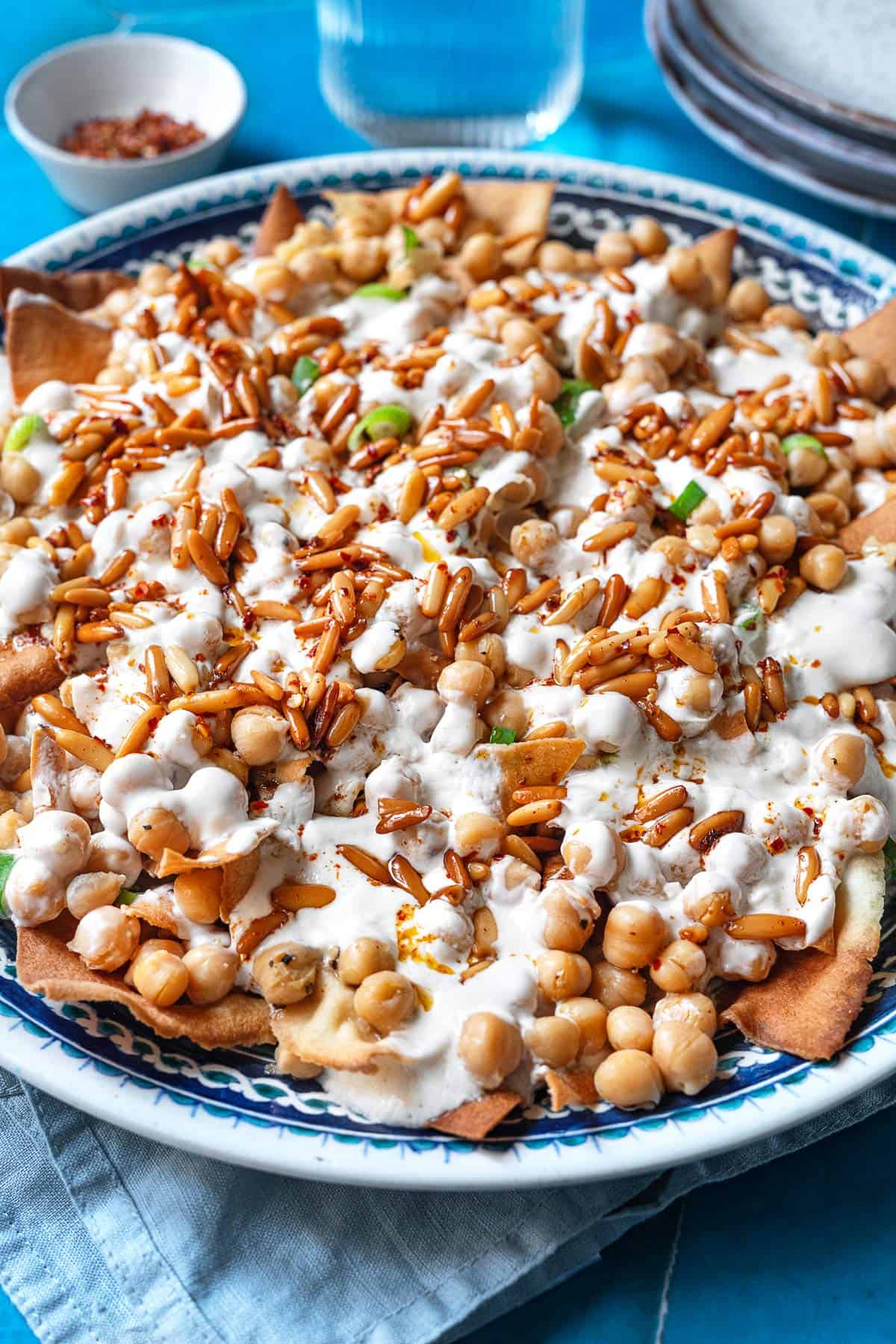 Fatteh (Spiced Chickpeas with Crispy Pita and Garlicky Yogurt) in a bowl.