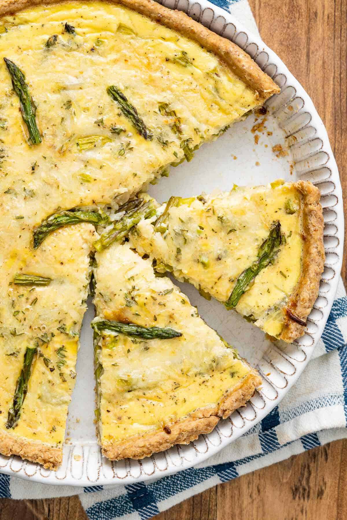 Overhead shot of two slices of asparagus quiche in the tin.