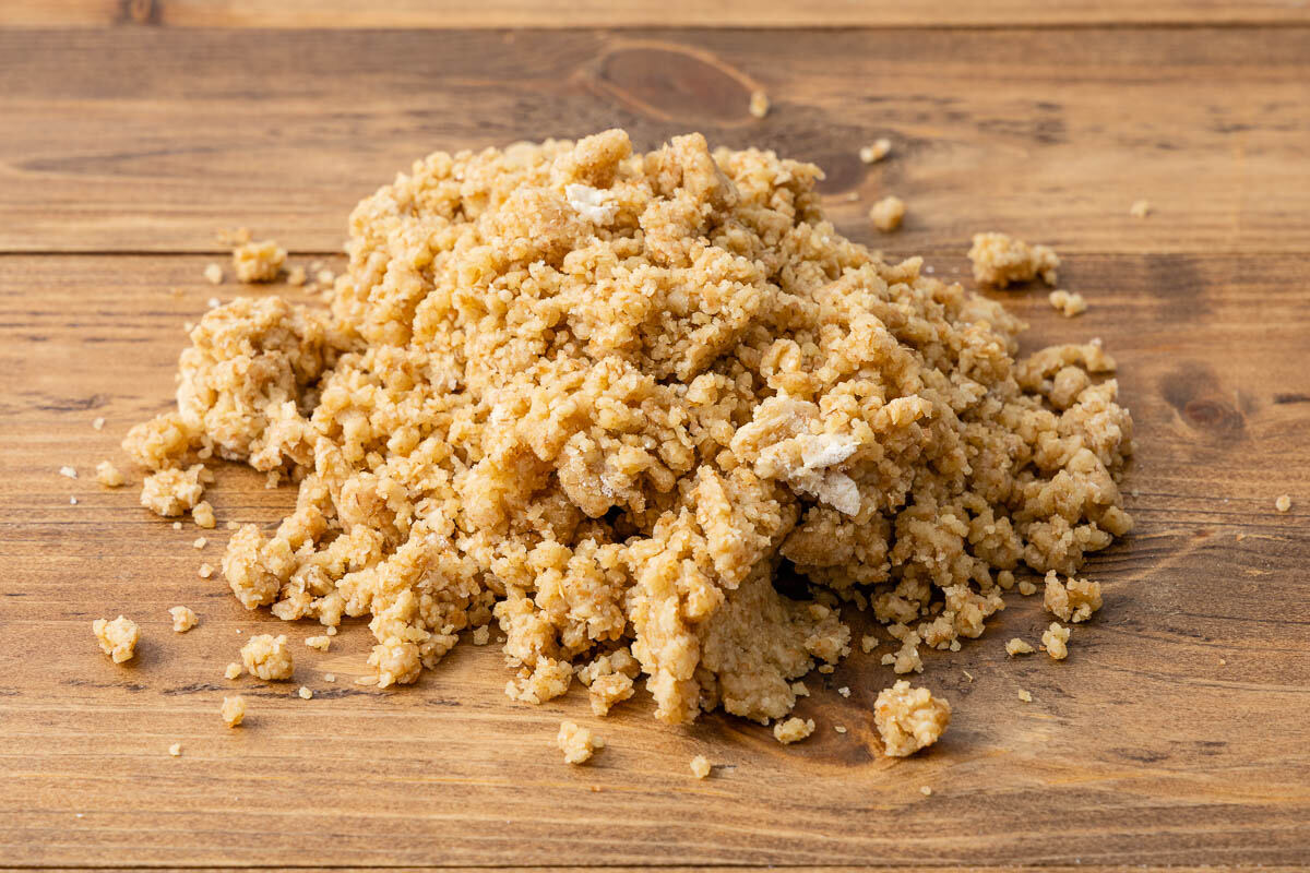 Crumbly quiche crust on a wood counter.