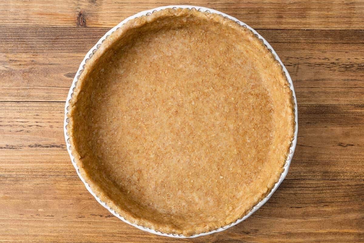 Quiche crust dough that's been rolled and pressed into a quiche tin.