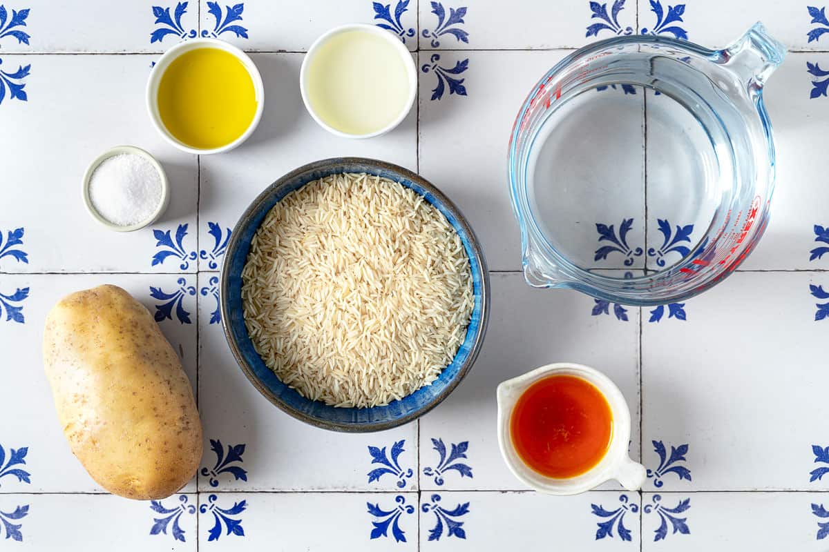 Ingredients for Persian Rice with Potato Tahdig, including rice, potato, oil, saffron, and salt.