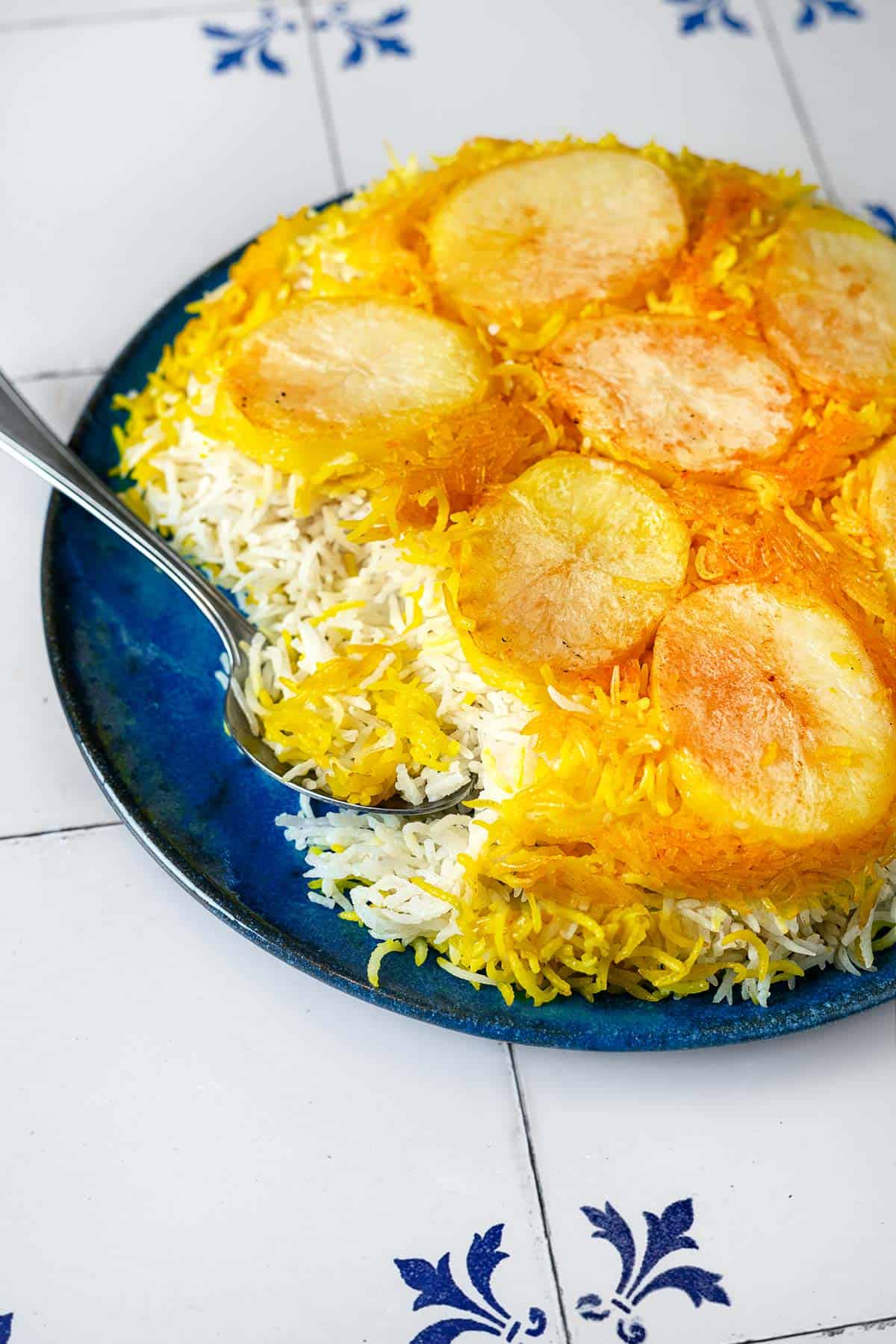 Closeup of Persian Rice with Potato Tahdig being scooped.