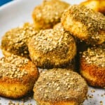 close up of a stack of fried goat cheese slices on a plate.