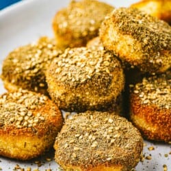 close up of a stack of fried goat cheese slices on a plate.