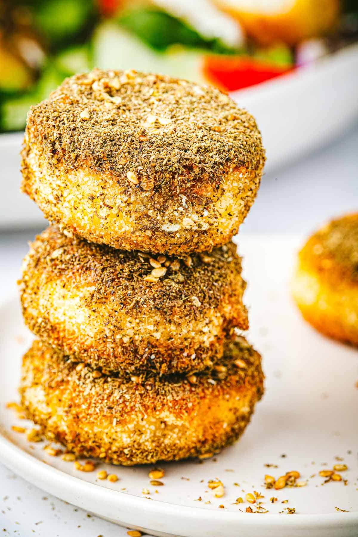 a stack of 3 fried goat cheese slices.