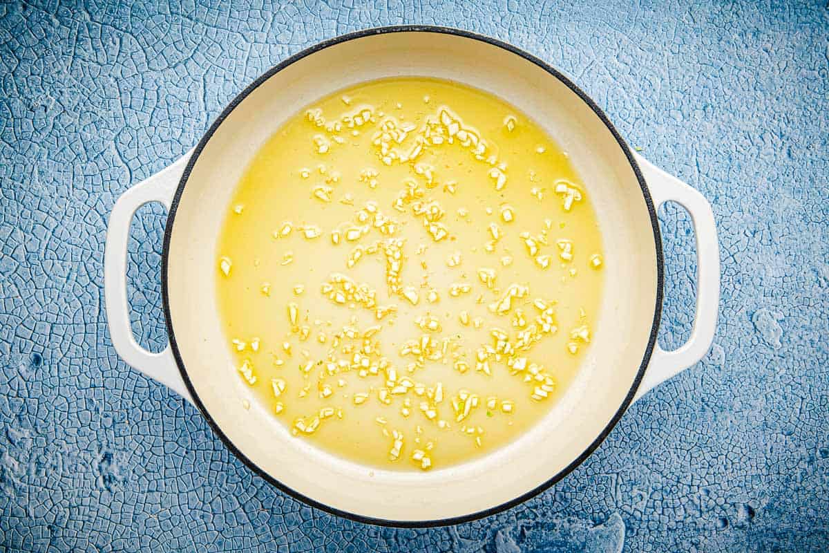 minced garlic cooking in a skillet.