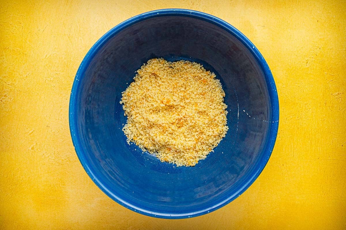 sugar and orange zest combined an a bowl.