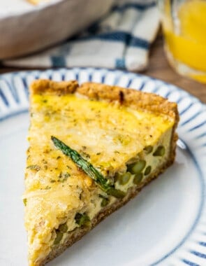 Close up of healthy asparagus quiche with a slice of asparagus on top.