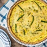 Overhead shot of unsliced asparagus quiche in the tin.