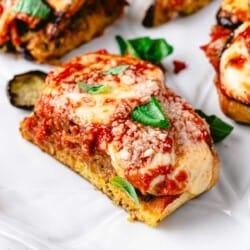 a eggplant parmesan sandwich slice on a plate.