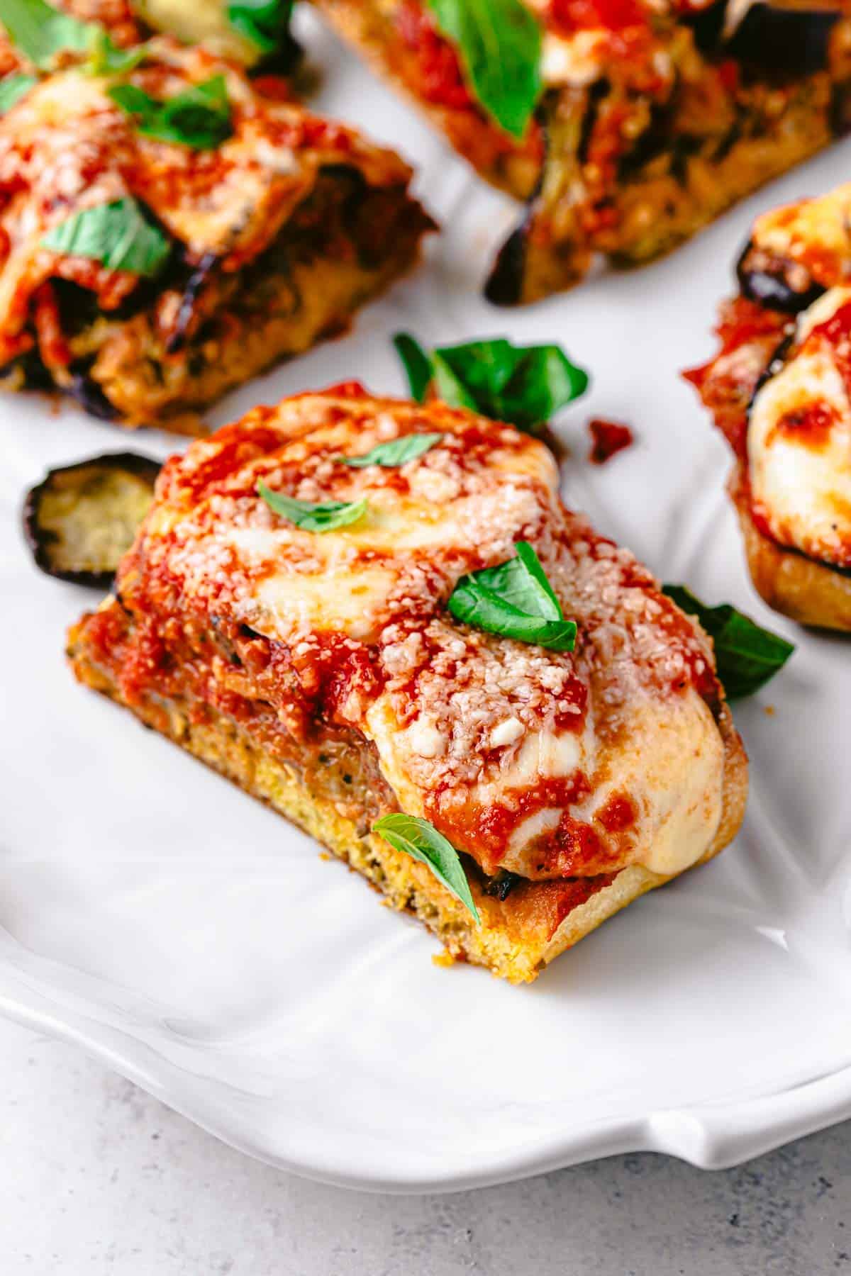 a eggplant parmesan sandwich slice on a plate.