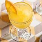 overhead shot of one glass of agua de valencia garnished with an orange slice.