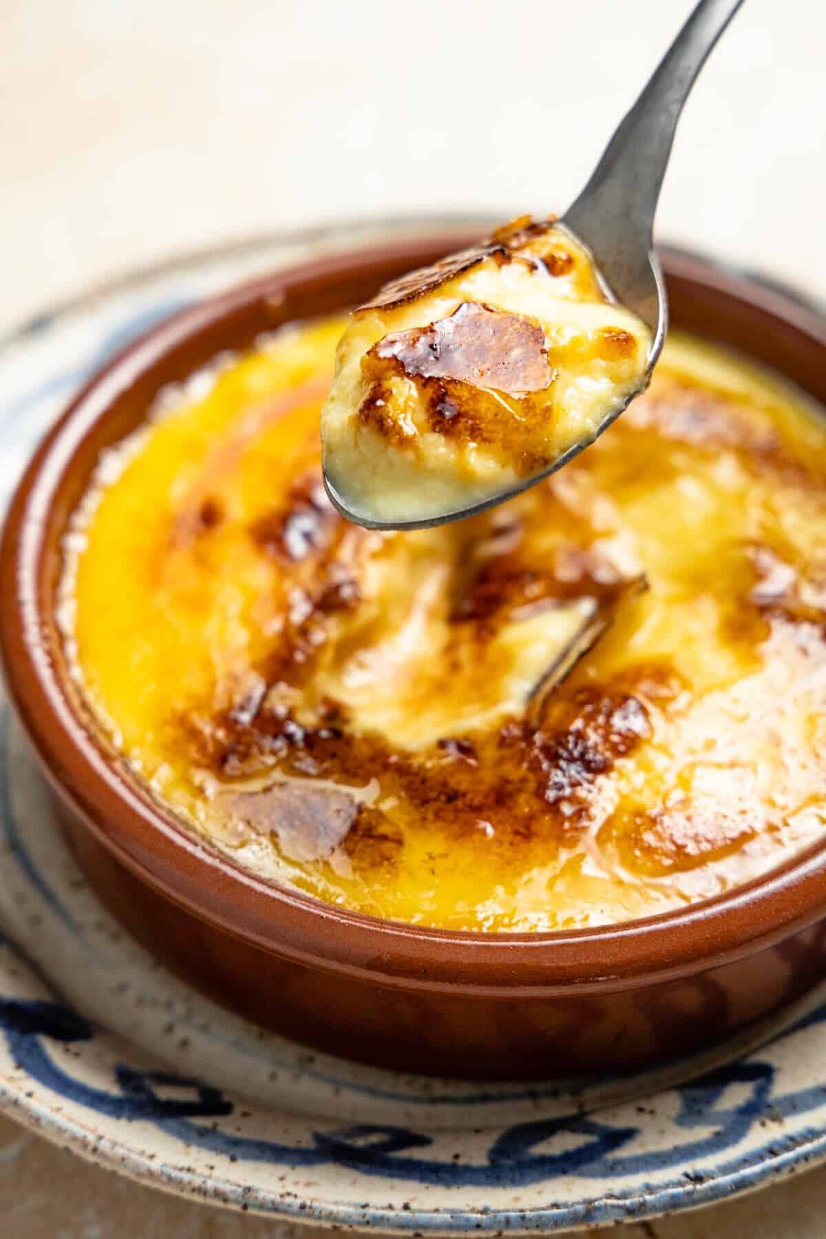 Bite of Crema Catalana with a brown caramelized crust.