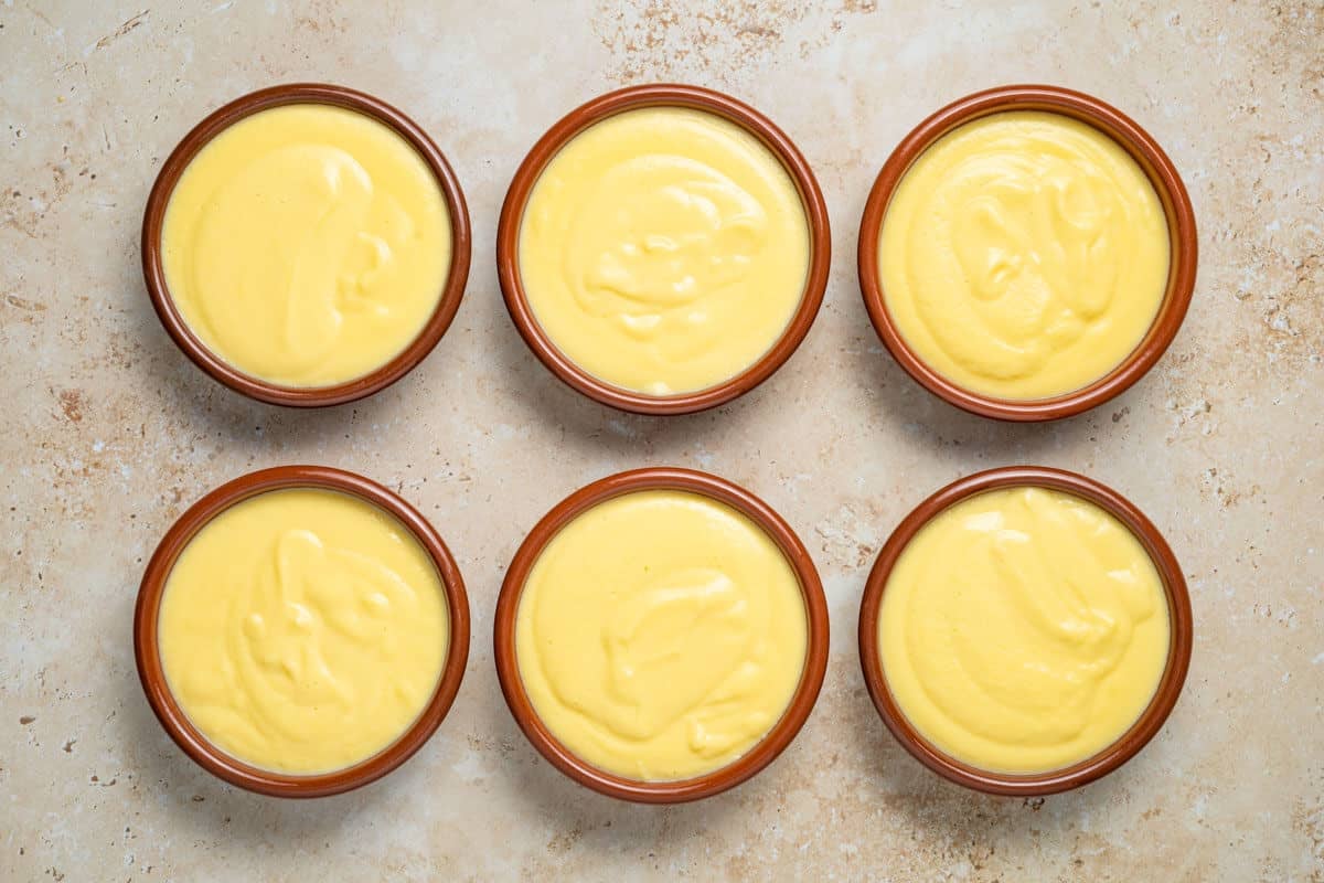 Six Crema Catalana that are ready to be torched.