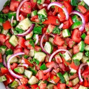 A cucumber tomato salad in a bowl.