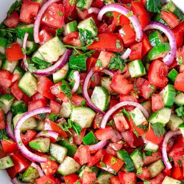 A cucumber tomato salad in a bowl.