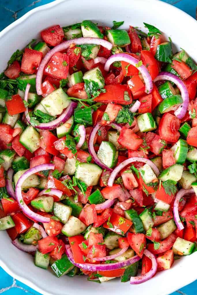 A cucumber tomato salad in a bowl.