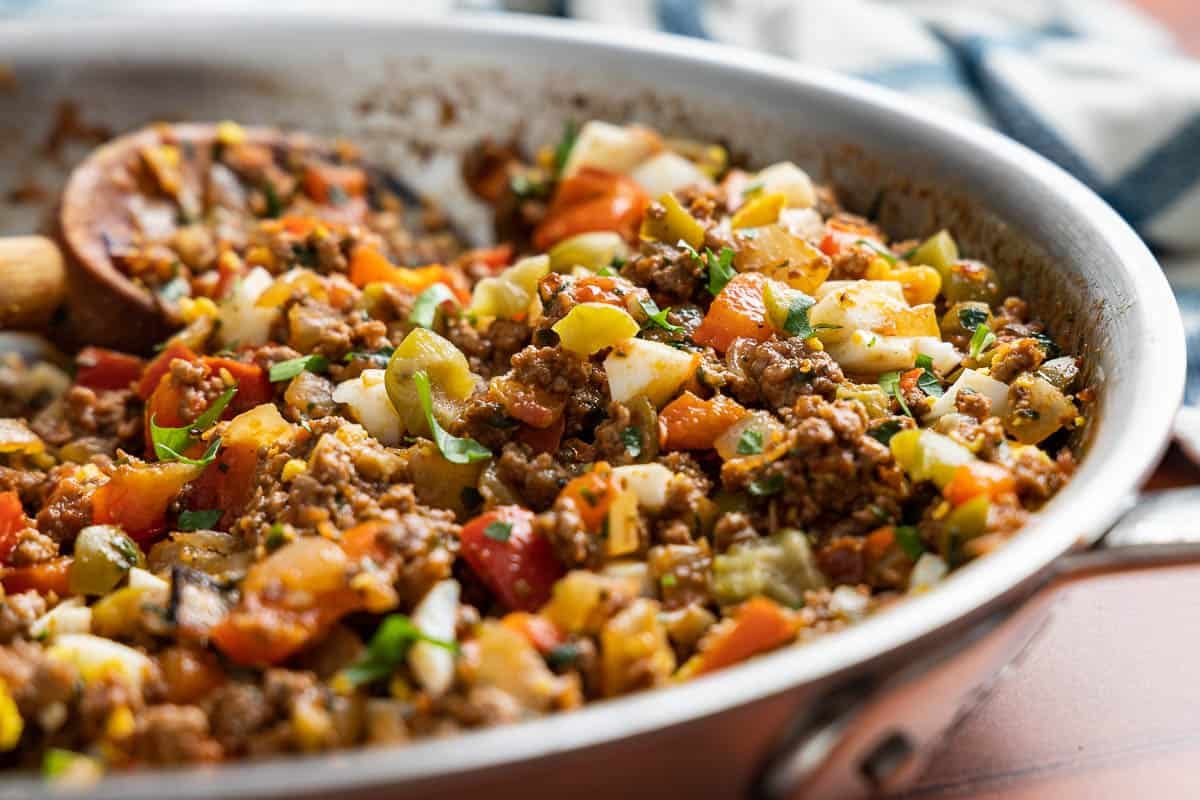 spanish beef empanadilla filling cooking in a skillet.