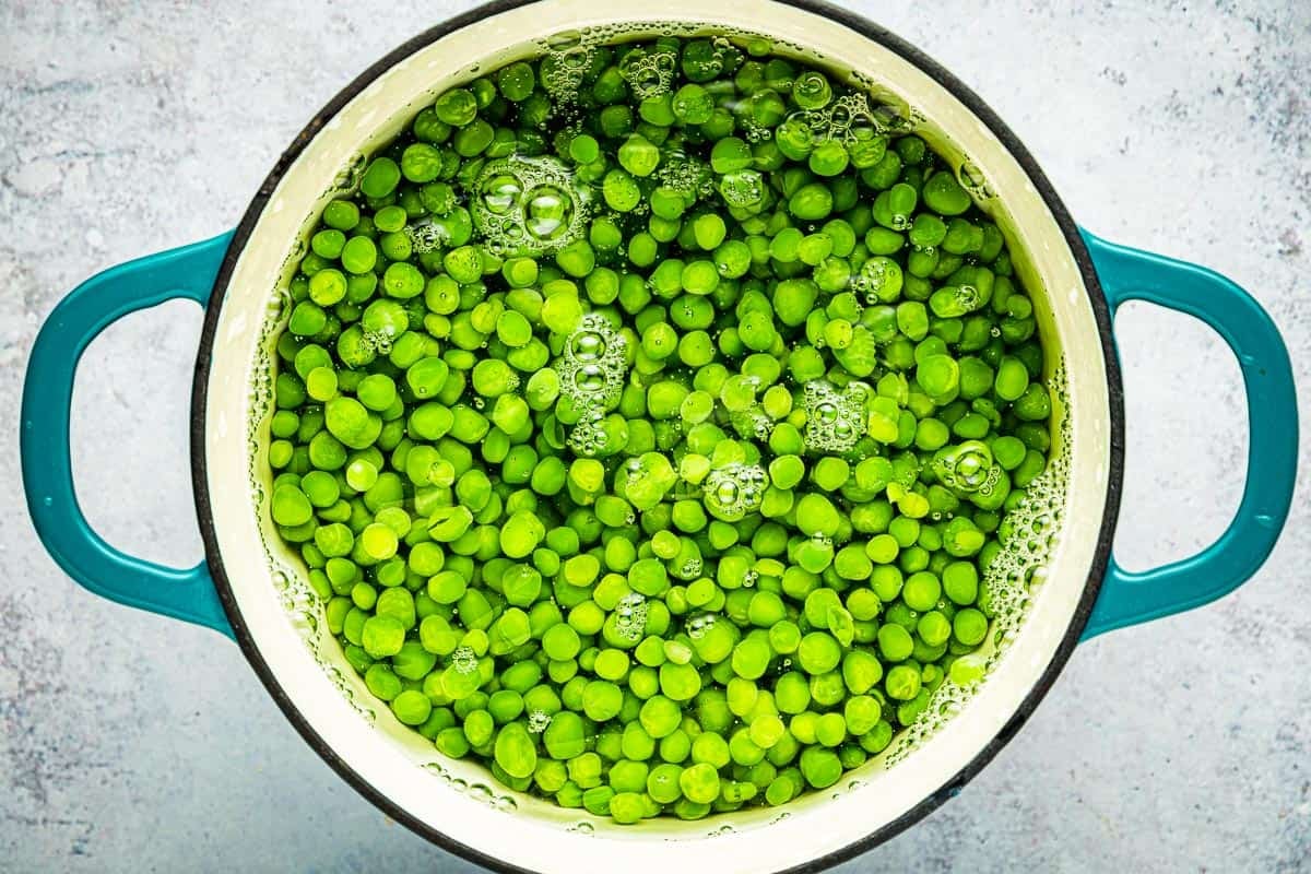 peas simmering in water in a pot.