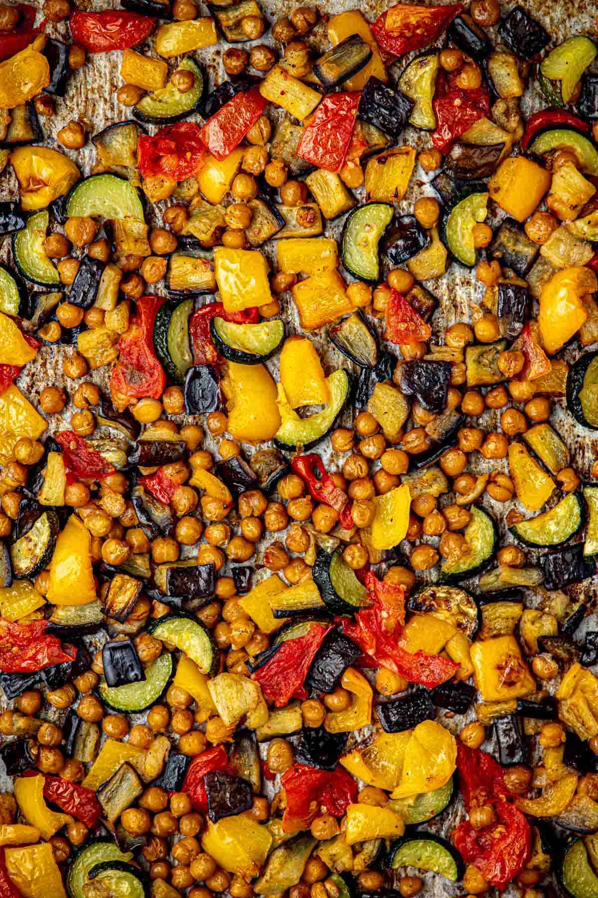 Close up shot of roasted zucchini, tomatoes, eggplant, bell peppers, and chickpeas.