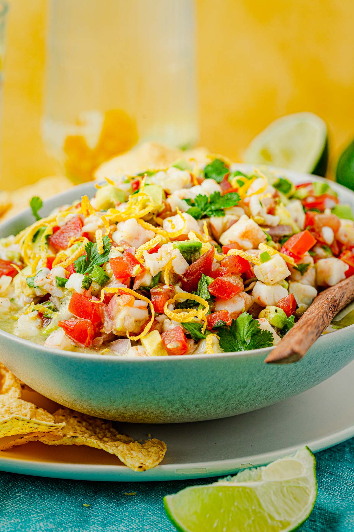 shrimp ceviche in a bowl with a wooden spoon.