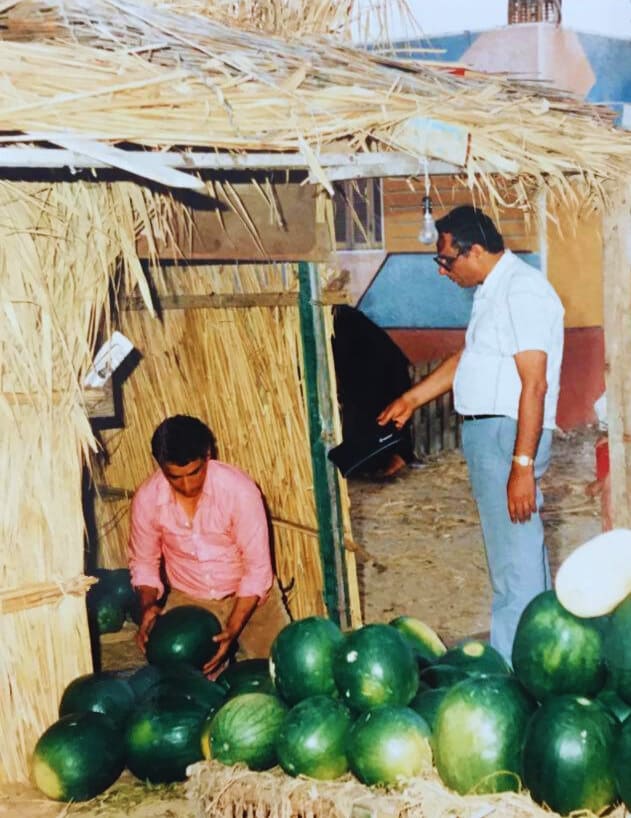 Suzy's father at the market in Port Said, Egypt, selecting watermelons 