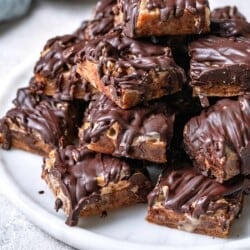 chocolate covered date bars stacked on a plate.