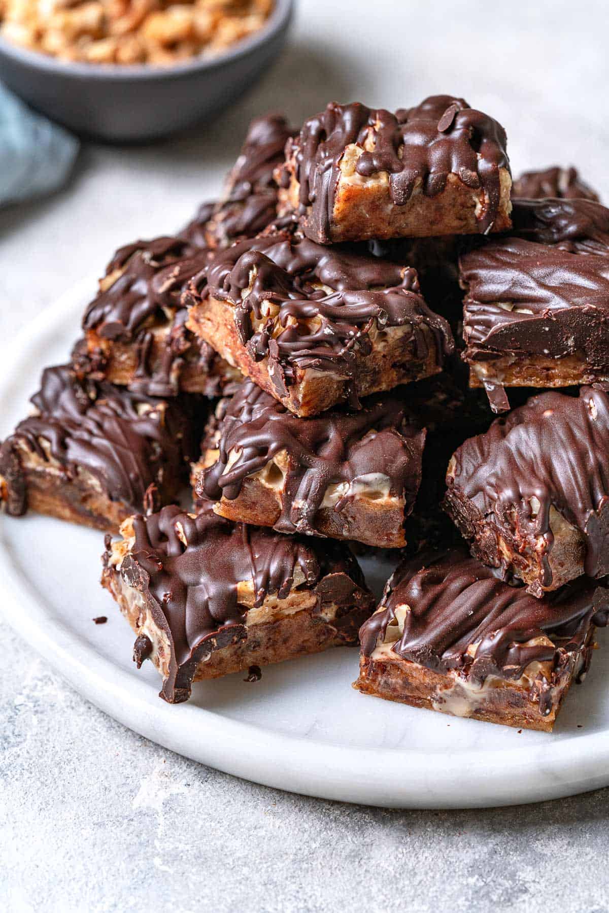 chocolate covered date bars stacked on a plate.