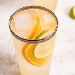 Overhead shot of the Eternal Sunshine Gin cocktail with a garnish of a lime and orange slice.