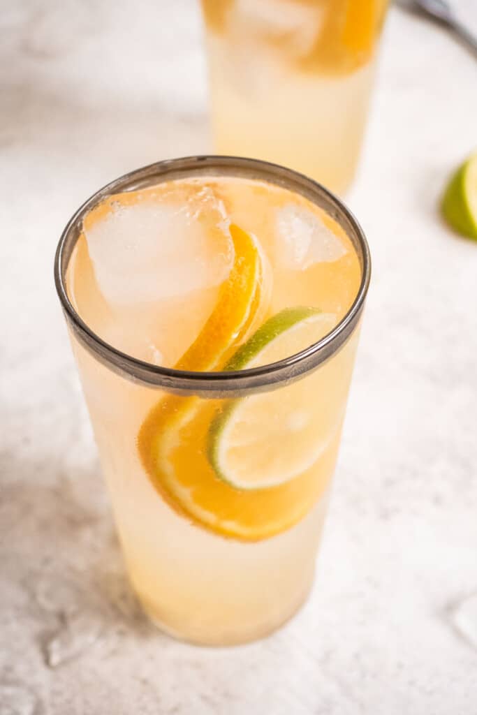 Overhead shot of the Eternal Sunshine Gin cocktail with a garnish of a lime and orange slice.