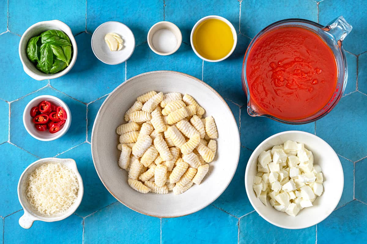 Ingredients for Gnocchi ala Sorrentina, including tomato sauce, cheese, red pepper, oil, salt, garlic, basil, and gnocchi.