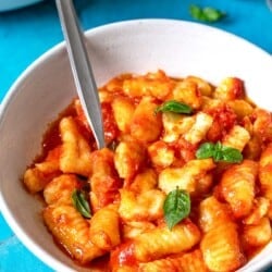 Bowl of Gnocchi alla Sorrentina with a metal spoon.