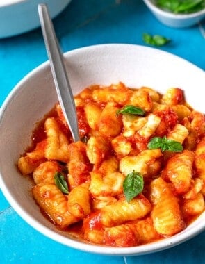 Bowl of Gnocchi alla Sorrentina with a metal spoon.